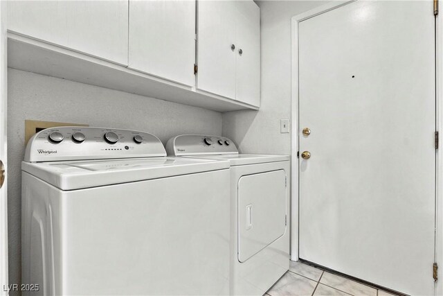 3827 Desert Marina Dr Unit 211, Laughlin, NV 89029 - laundry area featuring cabinet space, washing machine and dryer, and light tile patterned flooring