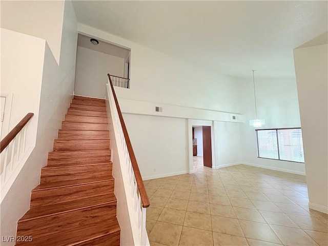5040 Jacarilla Ln, North Las Vegas, NV 89031 - stairway featuring tile patterned flooring, high vaulted ceiling, and baseboards