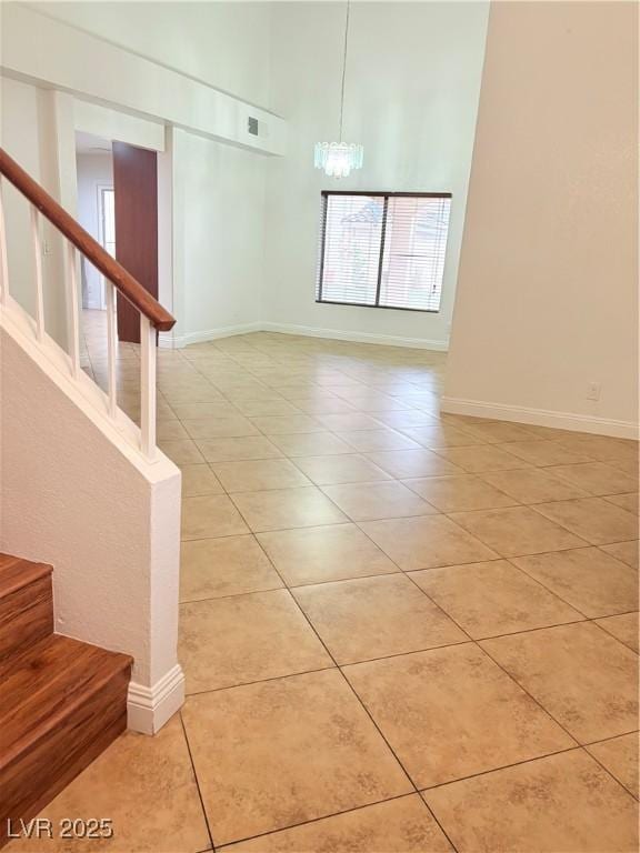5040 Jacarilla Ln, North Las Vegas, NV 89031 - empty room with light tile patterned floors, stairs, and a chandelier