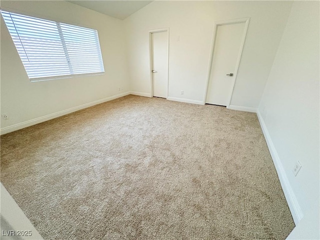 5040 Jacarilla Ln, North Las Vegas, NV 89031 - unfurnished room with carpet floors, vaulted ceiling, and baseboards