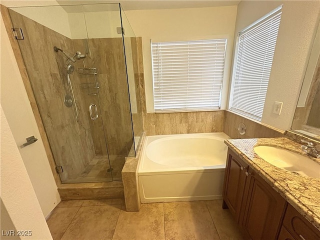 5040 Jacarilla Ln, North Las Vegas, NV 89031 - full bathroom featuring a bath, vanity, a stall shower, and plenty of natural light