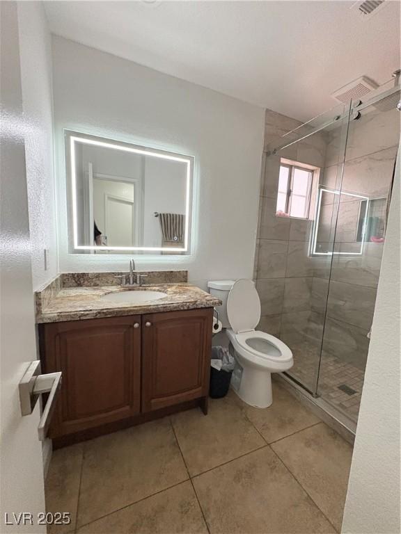 5040 Jacarilla Ln, North Las Vegas, NV 89031 - full bath with toilet, vanity, a stall shower, and tile patterned floors