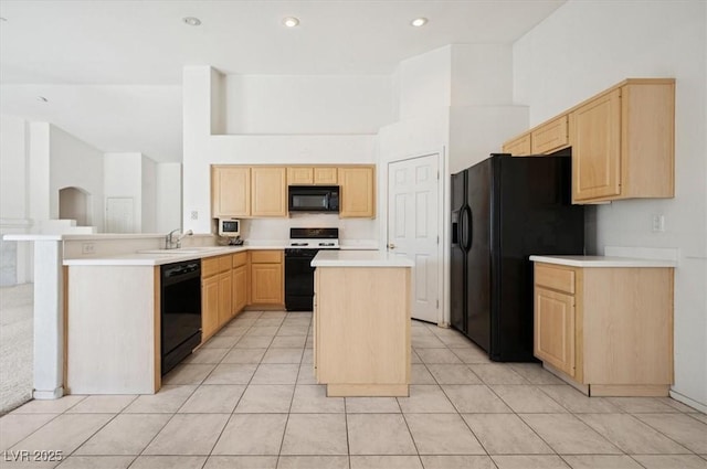 4323 Village Spring St, Las Vegas, NV 89147 - kitchen featuring black appliances, light brown cabinetry, light countertops, a center island, and recessed lighting