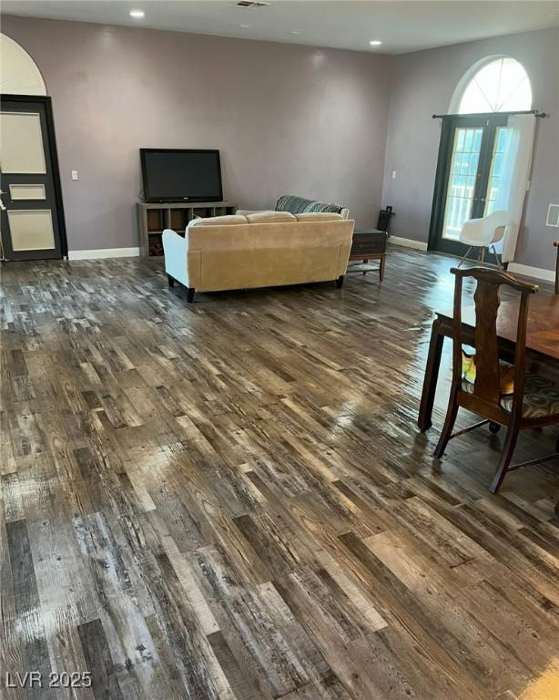 2855 Rice St, Logandale, NV 89021 - living room featuring dark wood-type flooring, recessed lighting, baseboards, and arched walkways