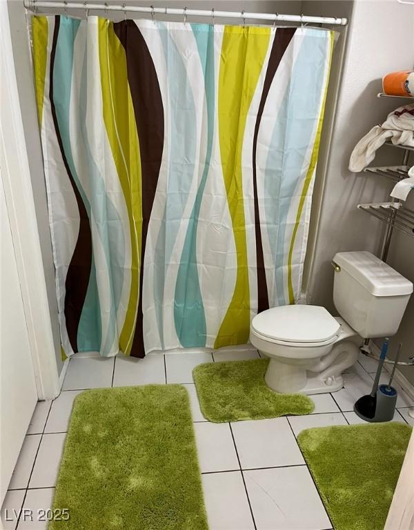 2855 Rice St, Logandale, NV 89021 - bathroom featuring toilet, tile patterned floors, and curtained shower
