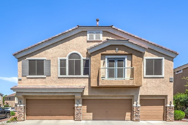 1554 Ward Frontier Ln, Henderson, NV 89002 - view of front facade featuring a garage, concrete driveway, stucco siding, and stone siding