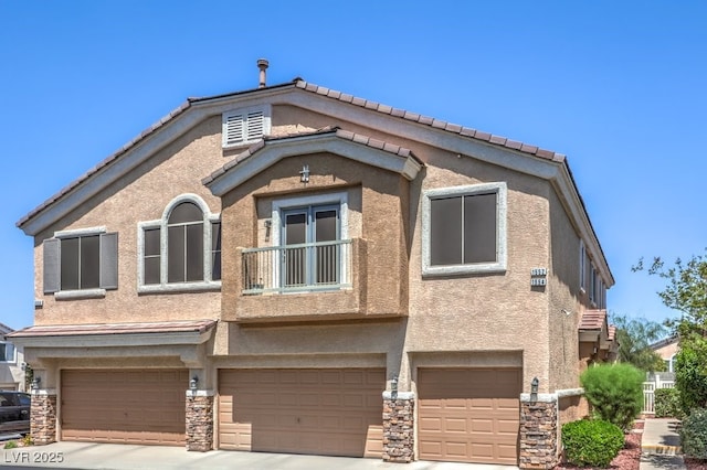 1554 Ward Frontier Ln, Henderson, NV 89002 - view of front of property with a garage, stone siding, stucco siding, and driveway