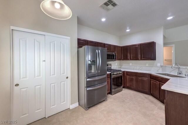 1554 Ward Frontier Ln, Henderson, NV 89002 - kitchen with appliances with stainless steel finishes, a sink, recessed lighting, and dark brown cabinetry