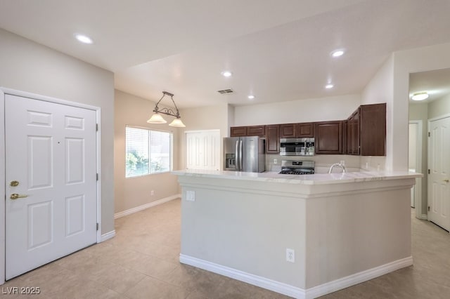 1554 Ward Frontier Ln, Henderson, NV 89002 - kitchen with stainless steel appliances, light countertops, a peninsula, a sink, and recessed lighting