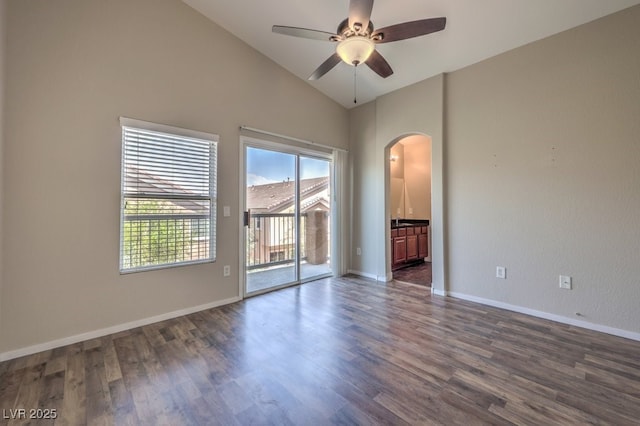 1554 Ward Frontier Ln, Henderson, NV 89002 - empty room featuring arched walkways, dark wood-type flooring, a ceiling fan, baseboards, and high vaulted ceiling