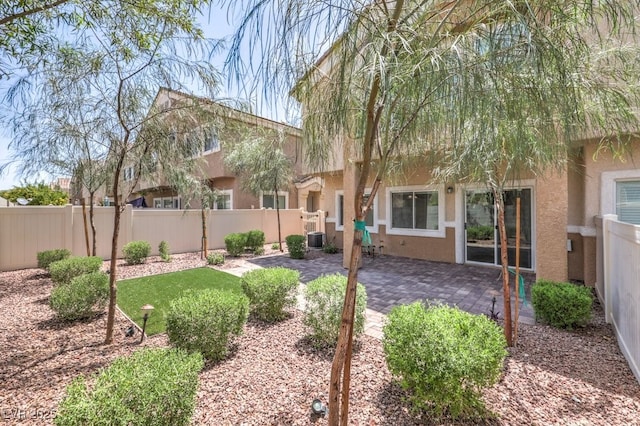 1554 Ward Frontier Ln, Henderson, NV 89002 - back of property featuring stucco siding, a fenced backyard, a patio, and central AC unit