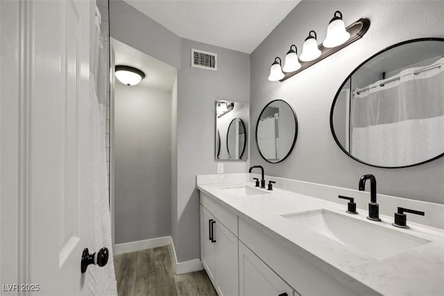 6008 Pebble Beach Blvd, Las Vegas, NV 89108 - full bath featuring double vanity, wood finished floors, and baseboards