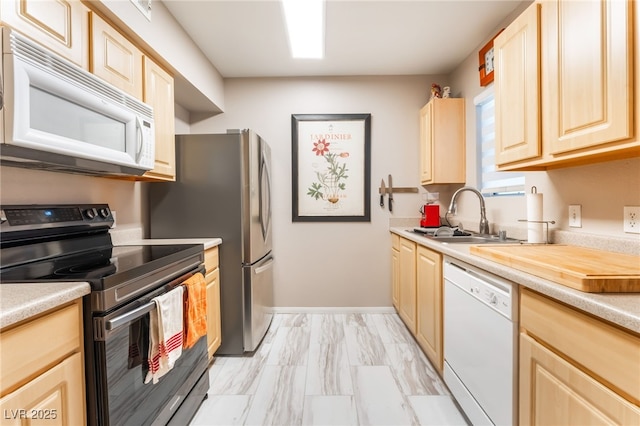 6955 N Durango Dr Unit 3013, Las Vegas, NV 89149 - kitchen featuring stainless steel appliances, a sink, light brown cabinetry, and light countertops