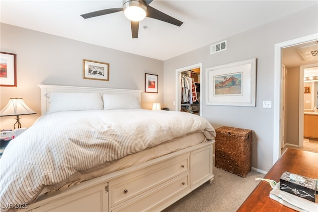 6955 N Durango Dr Unit 3013, Las Vegas, NV 89149 - bedroom featuring light carpet, a spacious closet, a closet, ceiling fan, and baseboards