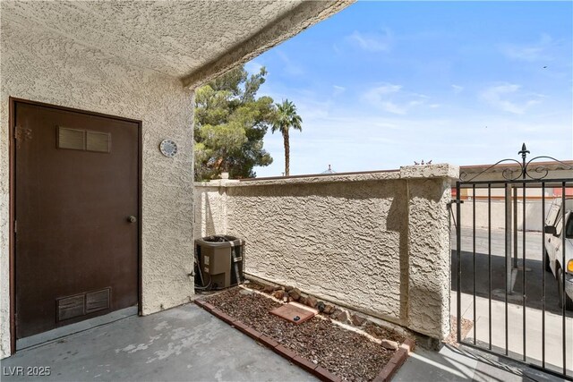 3923 Gogo Way Unit 106, Las Vegas, NV 89103 - view of property exterior with central AC unit, stucco siding, a gate, and a patio area