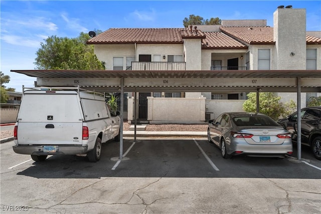 3923 Gogo Way Unit 106, Las Vegas, NV 89103 - view of front of home with covered parking, stucco siding, and a tile roof