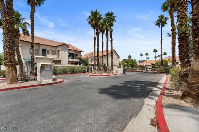 3923 Gogo Way Unit 106, Las Vegas, NV 89103 - view of asphalt street with a gate, curbs, a residential view, and a gated entry