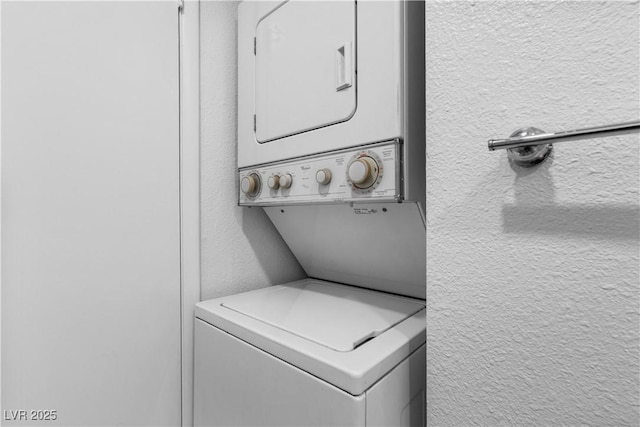 3923 Gogo Way Unit 106, Las Vegas, NV 89103 - laundry room featuring stacked washer and clothes dryer and a textured wall