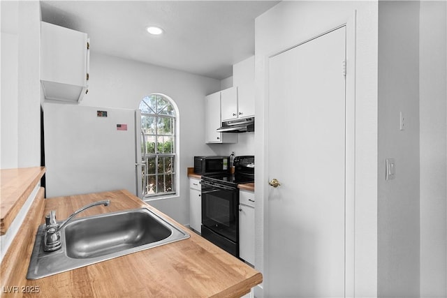 3923 Gogo Way Unit 106, Las Vegas, NV 89103 - kitchen featuring black / electric stove, freestanding refrigerator, under cabinet range hood, a sink, and white cabinetry