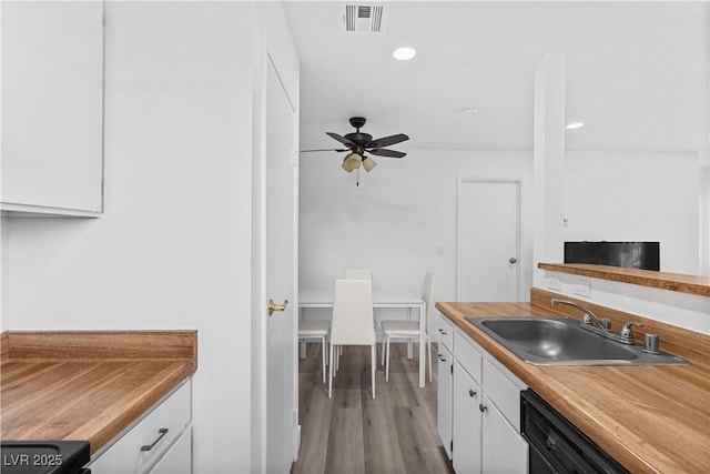 3923 Gogo Way Unit 106, Las Vegas, NV 89103 - kitchen featuring a sink, white cabinets, light wood finished floors, ceiling fan, and dishwashing machine