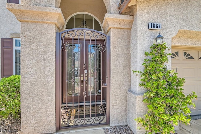 1667 Sabatini Dr, Henderson, NV 89052 - property entrance featuring stucco siding and a garage
