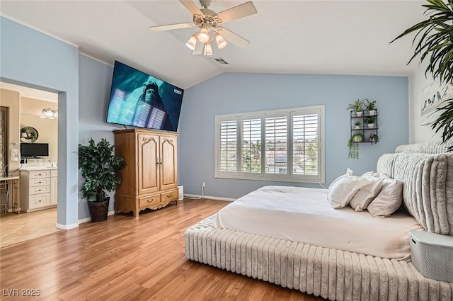 1667 Sabatini Dr, Henderson, NV 89052 - bedroom with light wood-type flooring, vaulted ceiling, ceiling fan, baseboards, and ensuite bath