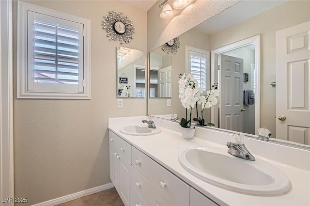 1667 Sabatini Dr, Henderson, NV 89052 - full bathroom with double vanity, baseboards, and tile patterned floors
