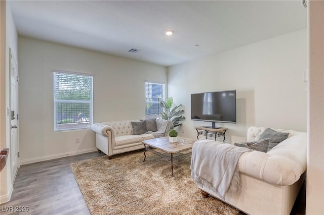 12728 Feathersong St, Henderson, NV 89044 - living area featuring plenty of natural light, wood finished floors, baseboards, and recessed lighting