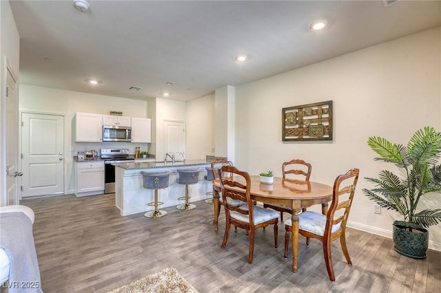 12728 Feathersong St, Henderson, NV 89044 - dining space with wood finished floors, baseboards, and recessed lighting
