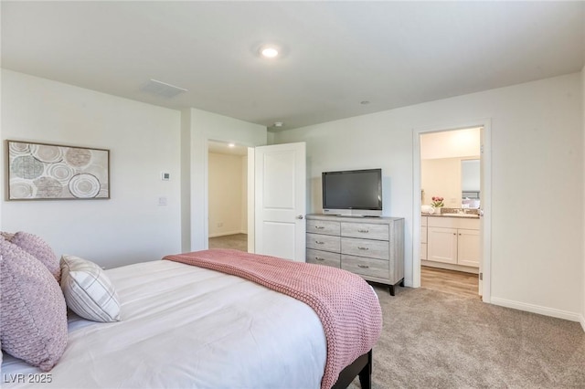 12728 Feathersong St, Henderson, NV 89044 - bedroom with light colored carpet, baseboards, and ensuite bathroom