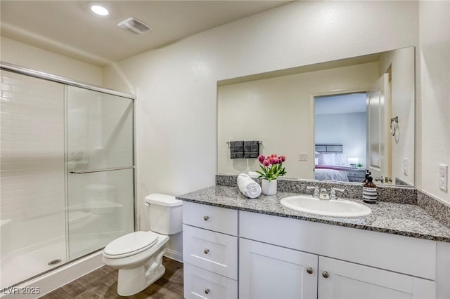 12728 Feathersong St, Henderson, NV 89044 - full bathroom with vanity, ensuite bathroom, a shower stall, toilet, and wood finished floors