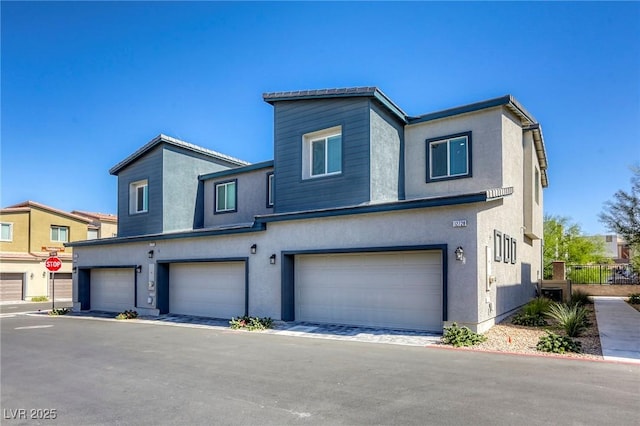 12728 Feathersong St, Henderson, NV 89044 - multi unit property with a garage and stucco siding