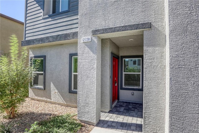 12728 Feathersong St, Henderson, NV 89044 - doorway to property with stucco siding