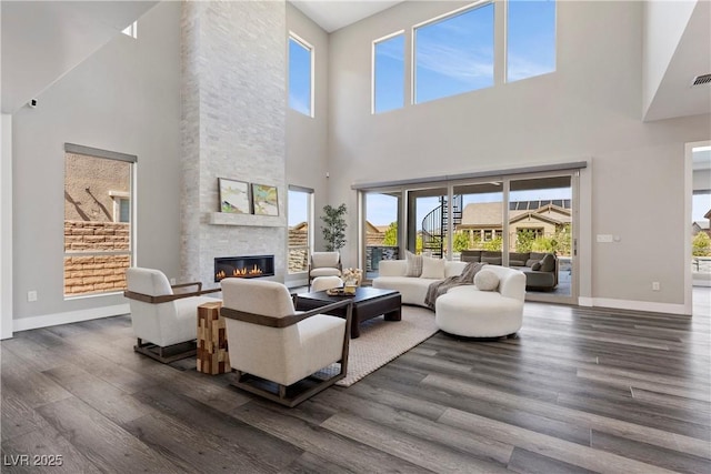 2890 Reverence Heights Ln, Las Vegas, NV 89138 - living room featuring a towering ceiling, dark wood-style floors, baseboards, and plenty of natural light