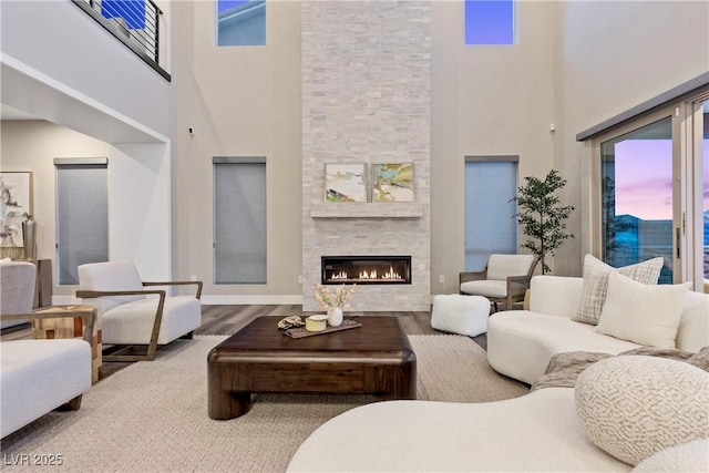 2890 Reverence Heights Ln, Las Vegas, NV 89138 - living room with a towering ceiling, a fireplace, and wood finished floors