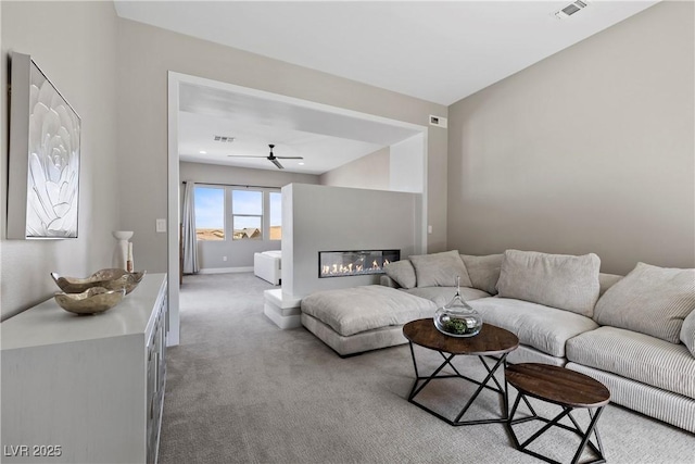 2890 Reverence Heights Ln, Las Vegas, NV 89138 - living room featuring carpet flooring, a ceiling fan, a glass covered fireplace, and baseboards