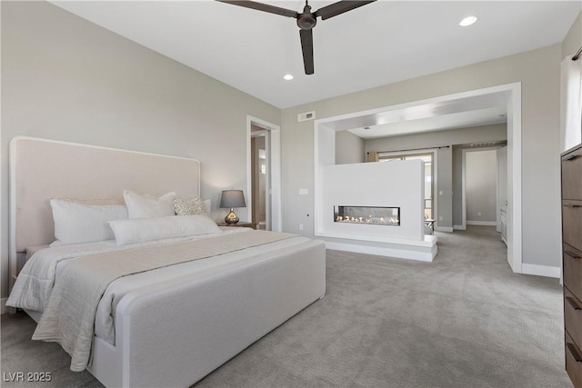 2890 Reverence Heights Ln, Las Vegas, NV 89138 - bedroom featuring baseboards, a glass covered fireplace, carpet, ceiling fan, and recessed lighting