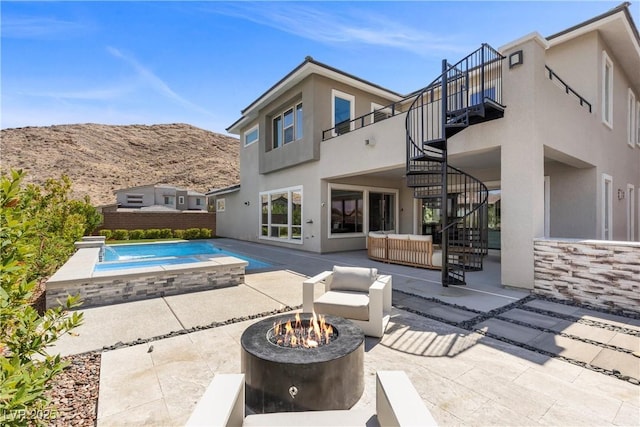 2890 Reverence Heights Ln, Las Vegas, NV 89138 - view of swimming pool featuring stairs, a patio area, a hot tub, an outdoor living space with a fire pit, and a mountain view