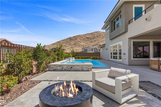 2890 Reverence Heights Ln, Las Vegas, NV 89138 - fenced backyard featuring a fire pit, a patio, and a mountain view