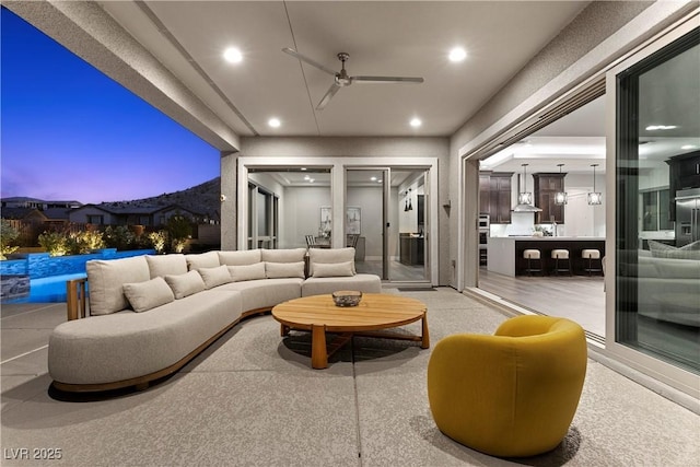 2890 Reverence Heights Ln, Las Vegas, NV 89138 - patio terrace at dusk featuring ceiling fan, an outdoor pool, an outdoor living space, and a patio