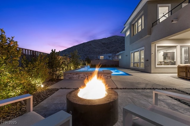 2890 Reverence Heights Ln, Las Vegas, NV 89138 - view of patio / terrace with a fire pit and a mountain view