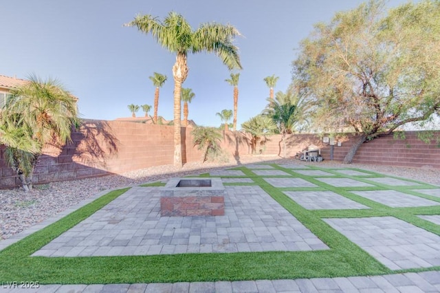 6826 Dovecote Ave, North Las Vegas, NV 89084 - fenced backyard featuring an outdoor fire pit and a patio area