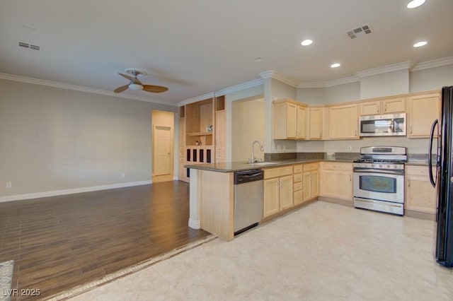 6826 Dovecote Ave, North Las Vegas, NV 89084 - kitchen with appliances with stainless steel finishes, light brown cabinetry, a sink, ornamental molding, and dark countertops
