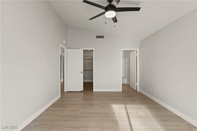 3936 Applecrest St, Las Vegas, NV 89108 - unfurnished bedroom featuring lofted ceiling, light wood-style flooring, baseboards, a spacious closet, and ensuite bath