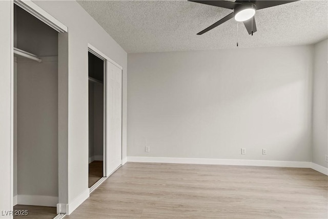3936 Applecrest St, Las Vegas, NV 89108 - unfurnished bedroom featuring a textured ceiling, light wood-type flooring, two closets, baseboards, and a ceiling fan