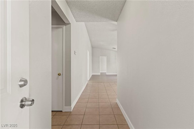 3936 Applecrest St, Las Vegas, NV 89108 - hallway with light tile patterned floors, a textured ceiling, and baseboards