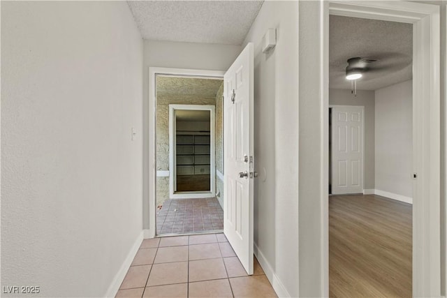 3936 Applecrest St, Las Vegas, NV 89108 - hall with a textured ceiling, baseboards, and light tile patterned flooring