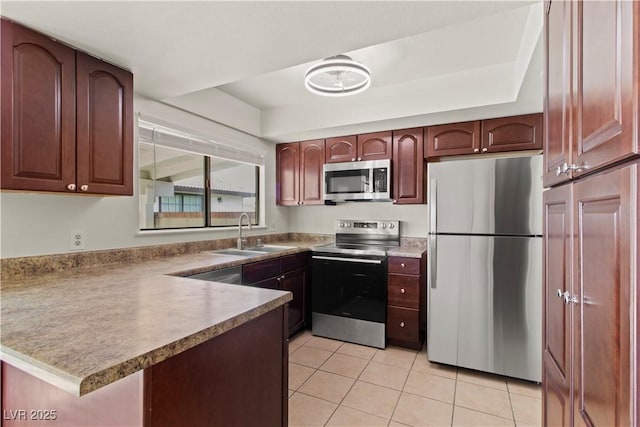 3936 Applecrest St, Las Vegas, NV 89108 - kitchen featuring stainless steel appliances, a sink, light tile patterned floors, and a peninsula