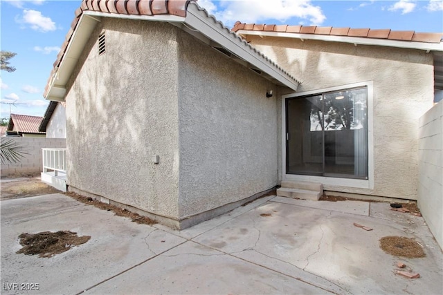 3936 Applecrest St, Las Vegas, NV 89108 - view of exterior entry with a patio, stucco siding, and a tiled roof