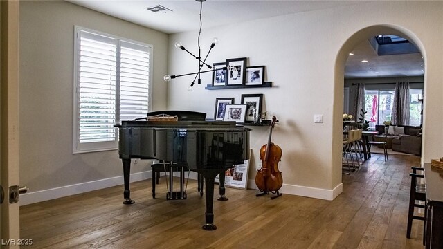 11731 Longworth Rd, Las Vegas, NV 89135 - sitting room with arched walkways, wood finished floors, and baseboards